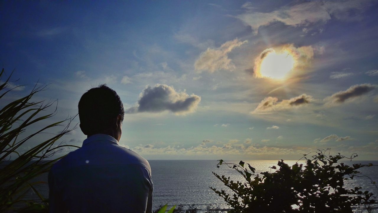 Lukman Nakib looking out over the sea at dusk